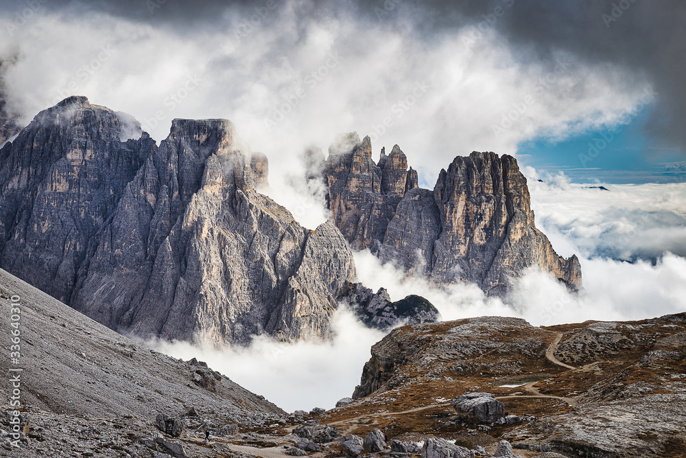 Amazing rocky mountains covered with clouds, Tre Cime di Lavaredo park, Dolomites, Italy