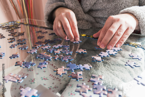 woman in dressing gown doing a puzzle