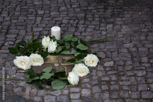 Stolpersteine (stumbling stone) with roses	