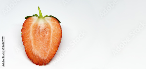 Strawberry in close-up. Red, ripe fruit on a white background. Spring natural food. The first spring delicacies.