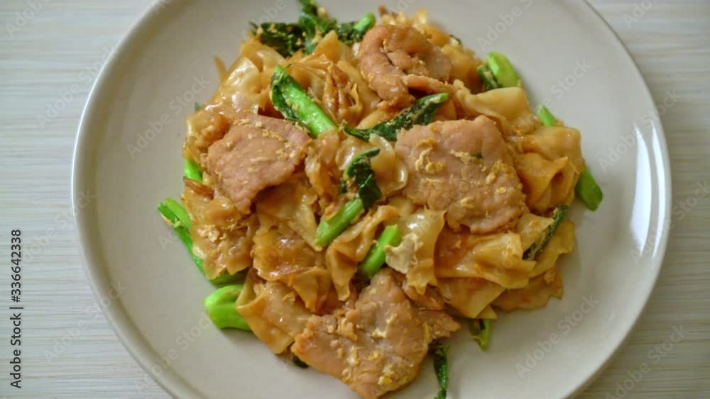 Stir-fried rice noodle with black soy sauce and pork and kale - Asian food style Stir-fried rice noodle with black soy sauce and pork and kale - Asian food style
