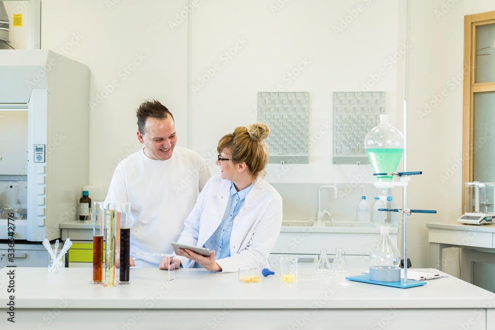 Fototapeta premium Two scientist working with tablet in CBD hemp laboratory