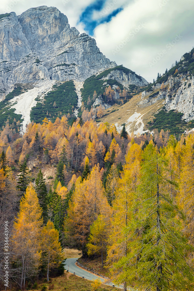 Vrsic pass - alpine road in Slovenia surrounded by colorful trees in autumn season
