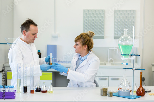 Two scientists working with CBD and CBDa oil