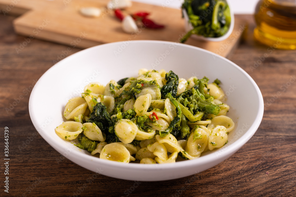 Typical dish of Italian cuisine, orecchiette with turnip greens. Orecchiette with cime di rapa, vegan food, healthy dish, fast lunch. Typical dish of Italian cuisine, orecchiette with turnip greens. Orecchiette with cime di rapa, vegan food, healthy dish, fast lunch.
