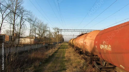 FPV drone flies quickly and maneuverable along freight carriages and an abandoned factory building