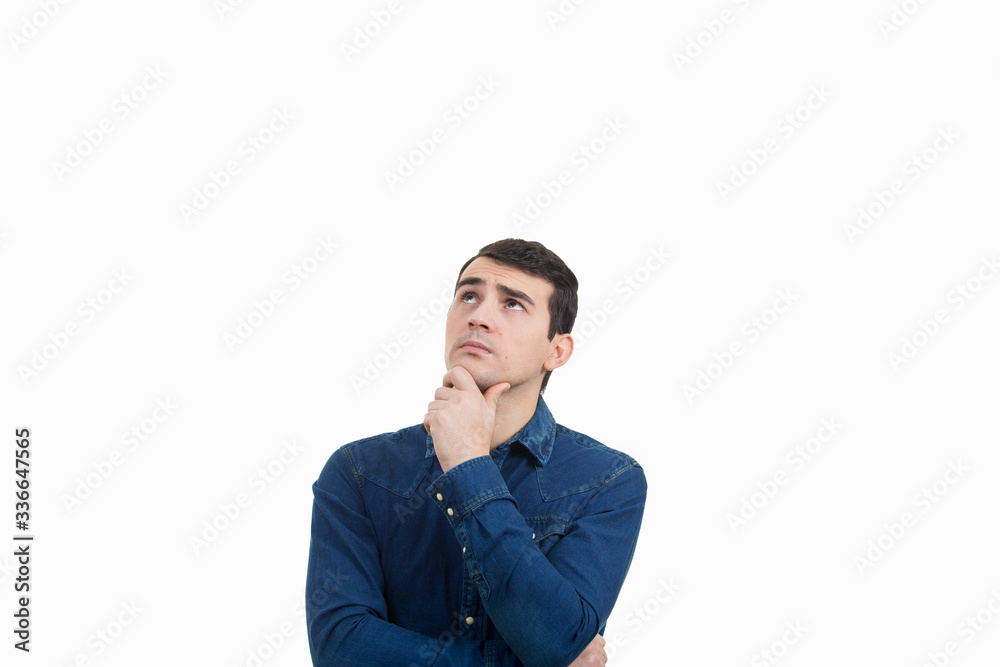 Portrait of unsure, perplexed man looking up and thinking for a solution. Thoughtful expression of a young man over white background. Portrait of unsure, perplexed man looking up and thinking for a solution. Thoughtful expression of a young man over white background.