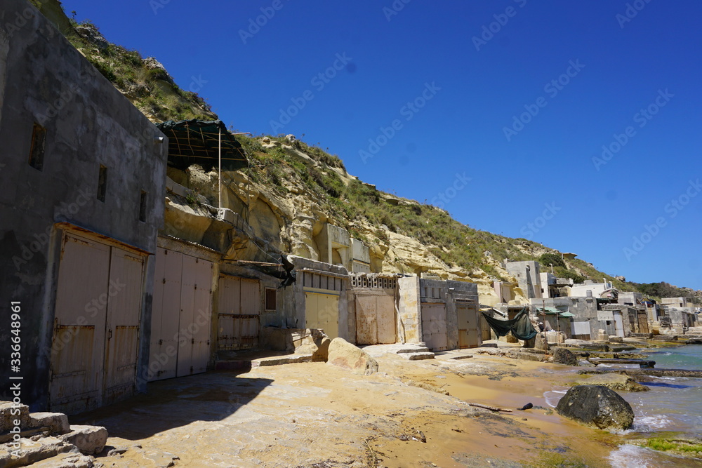 Boat garages at Gnejna Bay in Malta - also the place where local people spent their evenings together with family