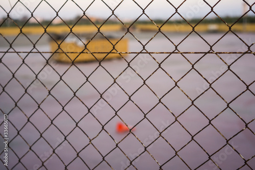 factory abandoned behind a fence photo