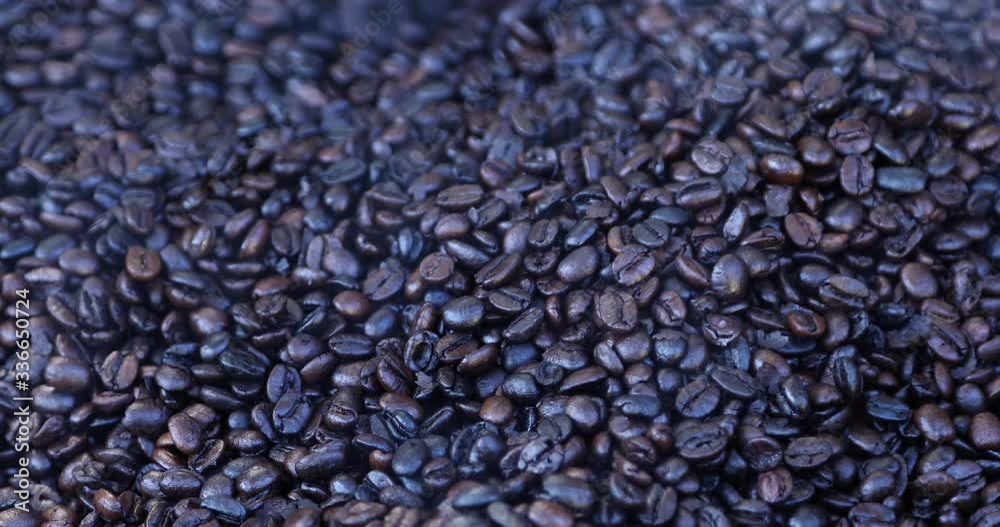 Coffee beans being manually mixed & roasted | Medium shot Coffee beans being manually mixed & roasted | Medium shot