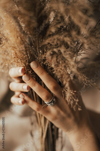 hands of a woman with a reed