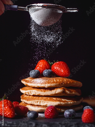 Pancakes with fruit and icing sugar