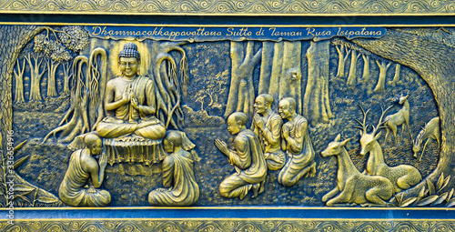 Canvas Print Batu, Indonesia - CIRCA Apr 2020: A golden wall carving in Dhammadipa Arama Temple, in Batu, East Java, Indonesia; depicting the first sermon given by Buddha