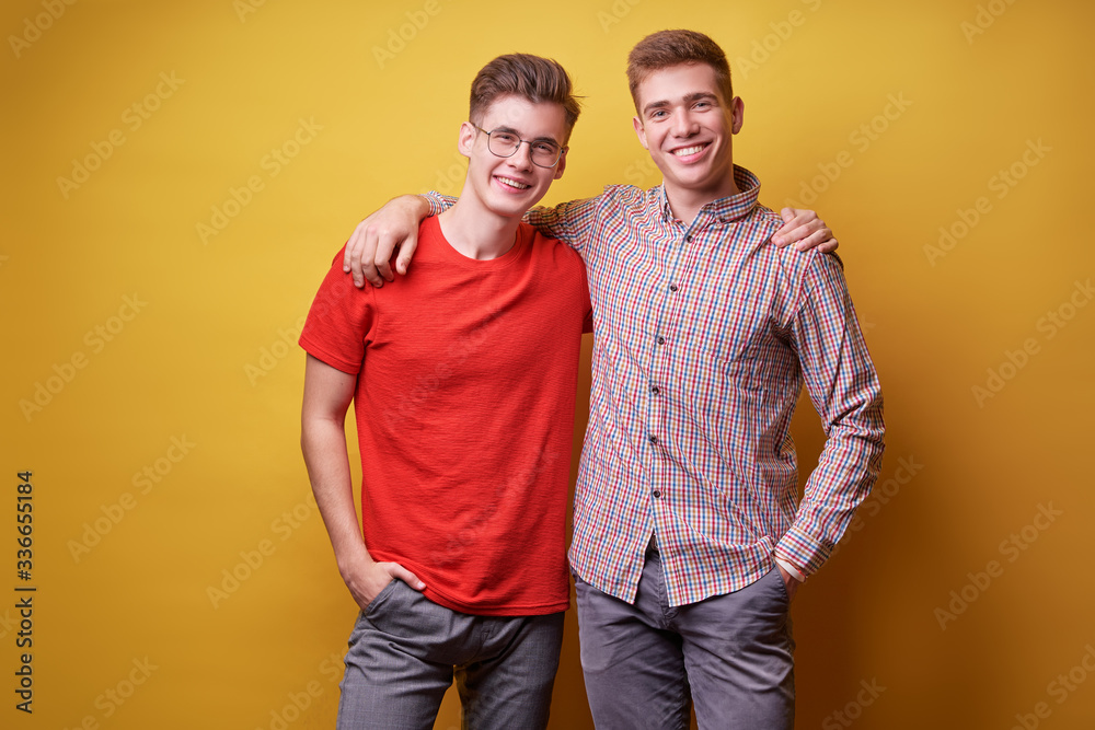 Fototapeta premium Colorful studio portrait of two happy smiling friends.
