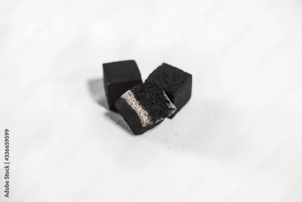 coal for a hookah smolders on a white background coal for a hookah smolders on a white background