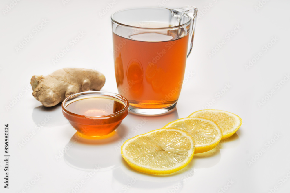 Ginger root, tea, honey, lemon on white background Ginger root, tea, honey, lemon on white background