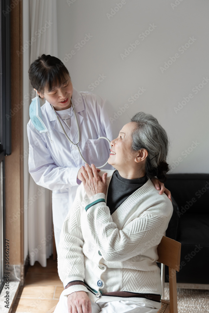 Fototapeta premium Young family doctor is talking with seniors
