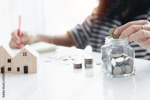 Woman's hand saving a coin ...