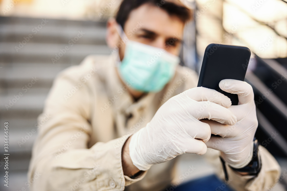 Man in protective suit with mask typing on smartphone mobile phone, prevent infection of Covid-19 virus coronavirus,contamination of germs or bacteria. Infection prevention and control of epidemic. Man in protective suit with mask typing on smartphone mobile phone, prevent infection of Covid-19 virus coronavirus,contamination of germs or bacteria. Infection prevention and control of epidemic.