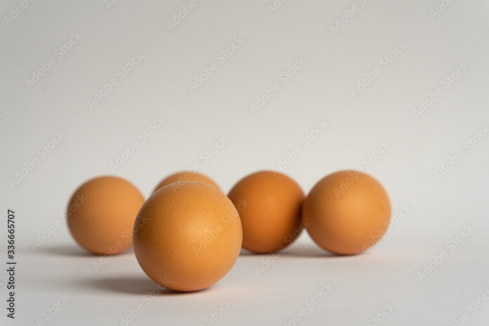 Five fresh brown chicken eggs in a row diagonally on grey background. Easter holiday Five fresh brown chicken eggs in a row diagonally on grey background. Easter holiday
