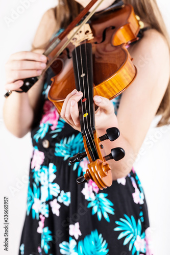 Close up of professional violin in hands of little violinist playing it