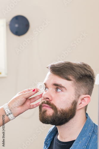 Medicine, health, ophthalmology concept - Ophthalmologist examines patient's eyes.