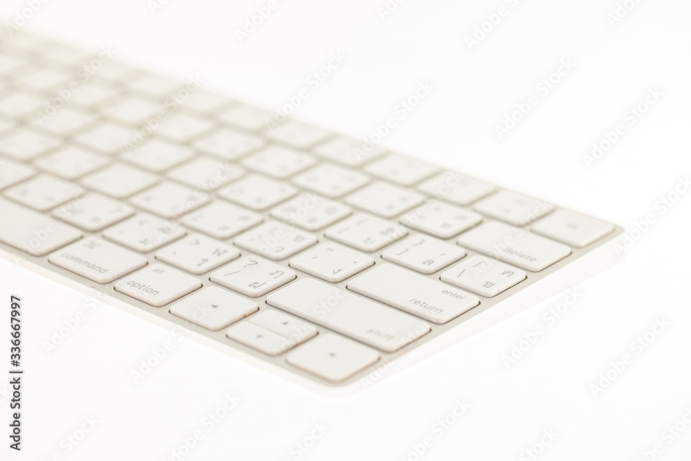 Close up of a white keyboard on white background. Image with soft focus. Close up of a white keyboard on white background. Image with soft focus.