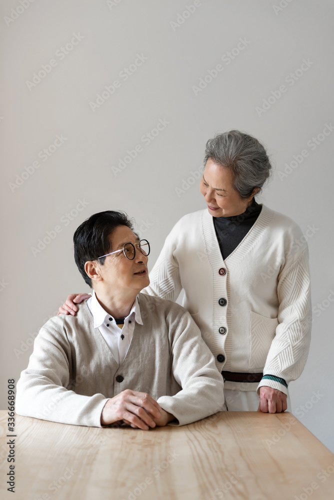 An Asian elderly couple sitting at the table An Asian elderly couple sitting at the table