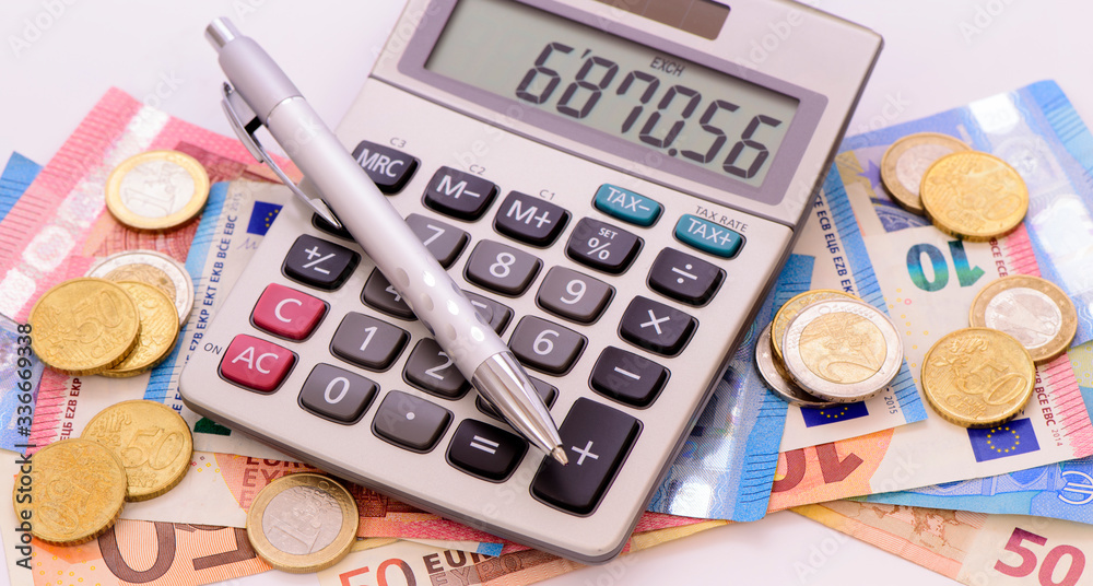 heap of banknotes of Euo currency with coins and calculator heap of banknotes of Euo currency with coins and calculator