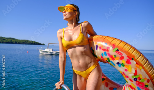 Sunny holiday. Woman with a air donut on the beach