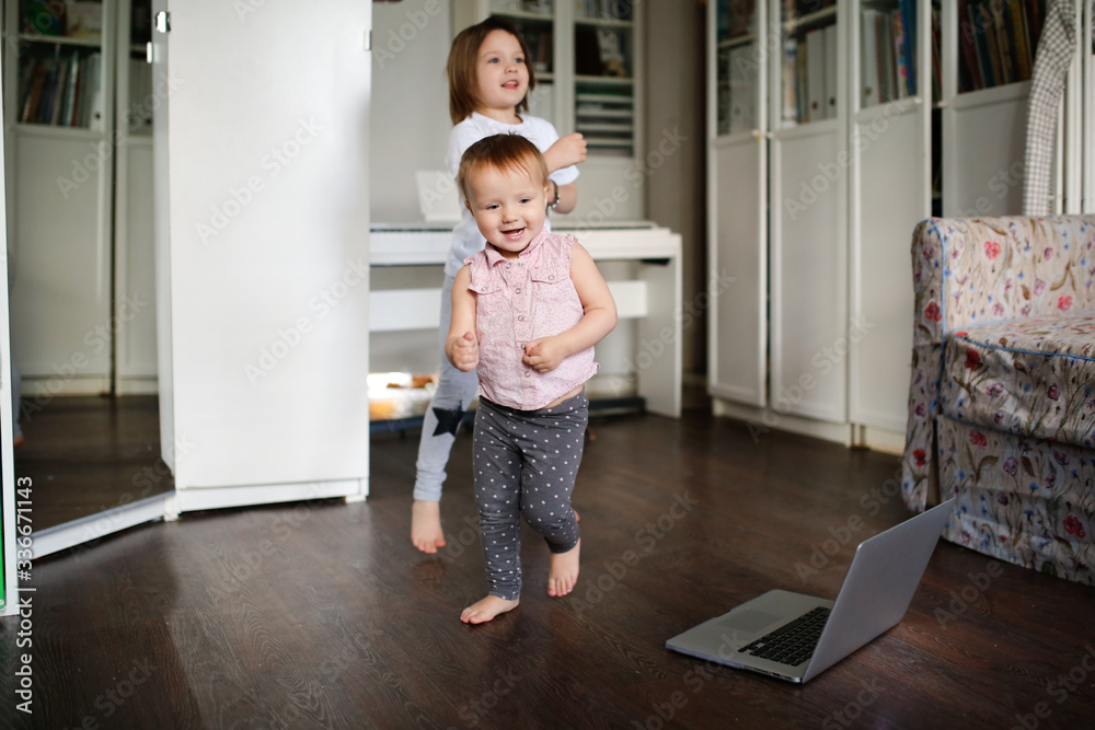 Funny children dance, do sports exercises online. Authentic lifestyle in a real interior Funny children dance, do sports exercises online. Authentic lifestyle in a real interior