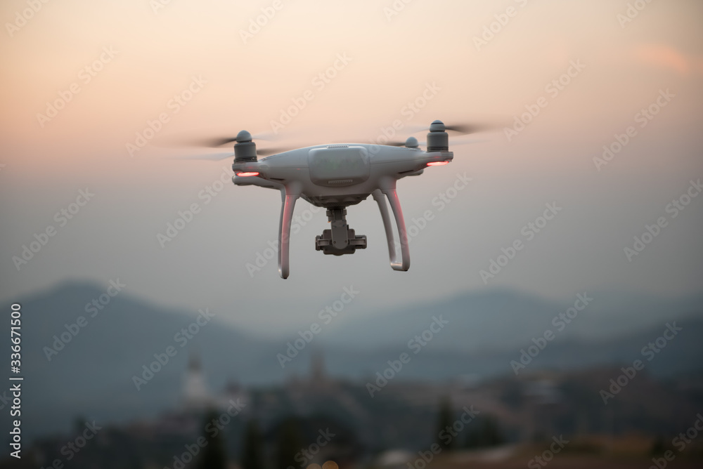 drone with the professional camera takes pictures of the misty mountains at sunset. drone with the professional camera takes pictures of the misty mountains at sunset.