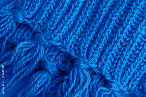 A fragment of a woolen scarf. The concept of care and warmth. Close-up.