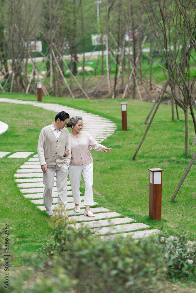 Fototapeta premium An Asian elderly couple walking in the community