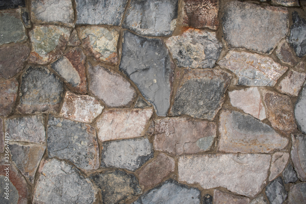 Stone wall for the backdrop. Cement joints. Rough edges, rock. Stone wall for the backdrop. Cement joints. Rough edges, rock.