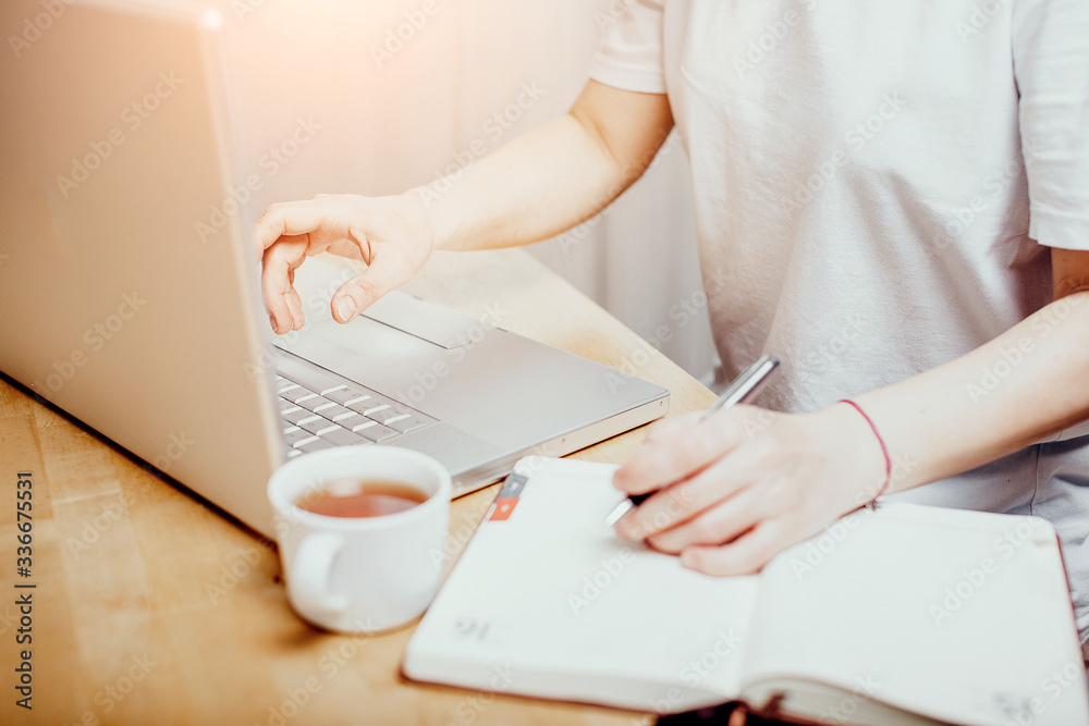 Hand holding credit card and and makes online shopping, work from home Hand holding credit card and and makes online shopping, work from home