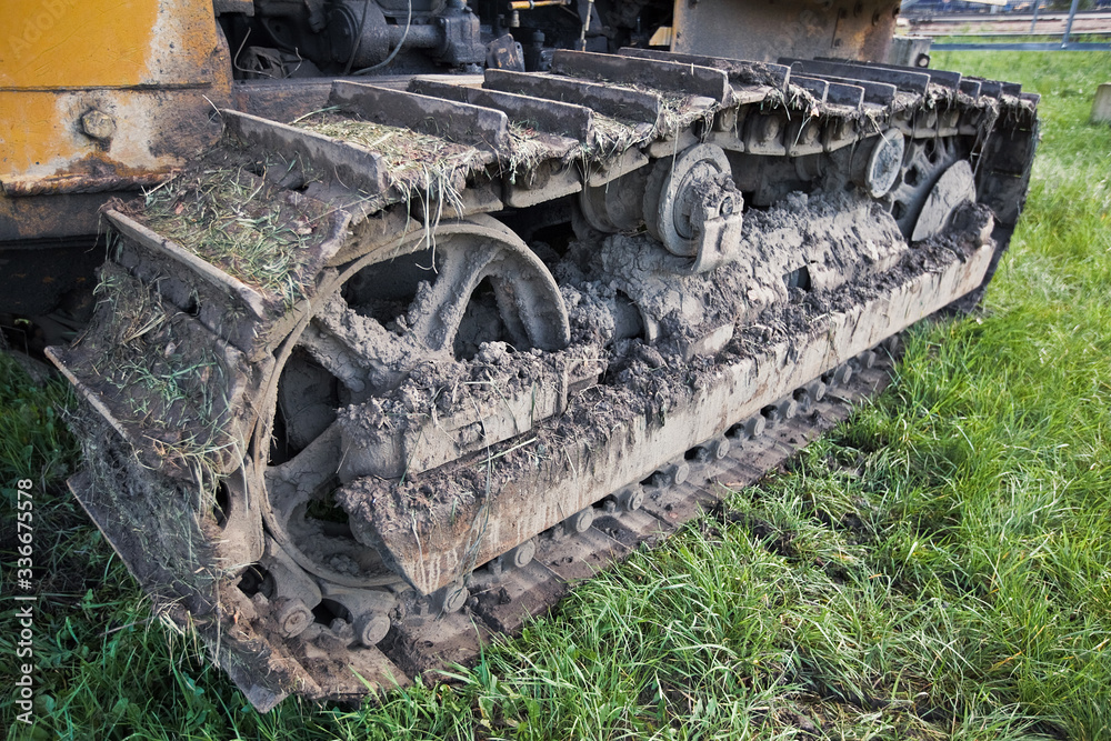 crawler tractor covered with earth