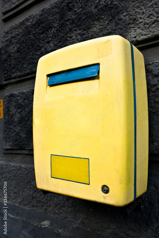 yellow mail box hanging on wall yellow mail box hanging on wall