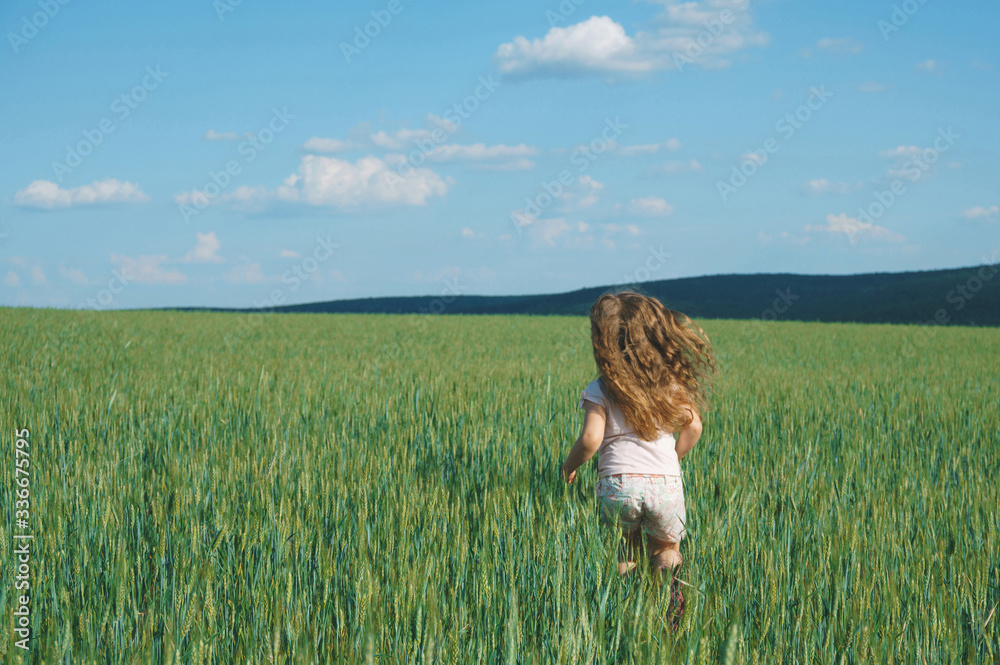 girl running in green grass girl running in green grass