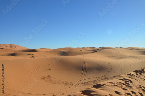 Merzouga is a small Moroccan town in the Sahara Desert  near the Algerian border. Beautiful sand dunes with blue sky.