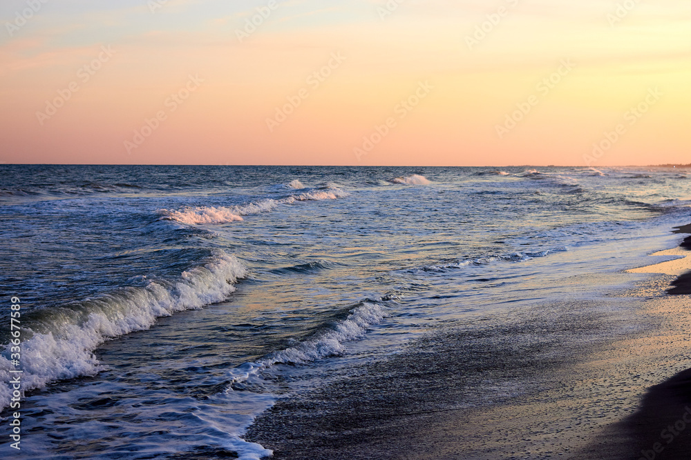 Сoast of the sea and waves at twilight sunset