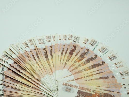 Russian banknotes are fanned out on an isolated white background.