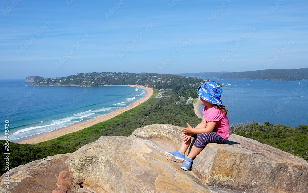 A little baby girl admiring a view of the scenic landscape of the Palm beach in Sydney, Australia
