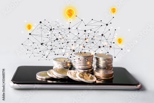 make money online,  business e- commerce concept with stack of coin on mobile phone with technology background