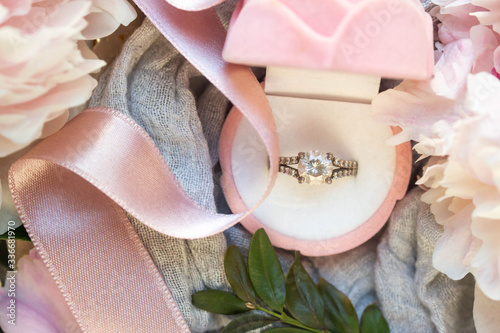 wedding ring in blue box with peony bouquete photo