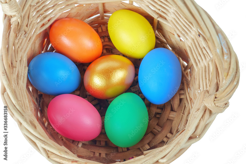Colorful Easter eggs in the basket on the white background Colorful Easter eggs in the basket on the white background