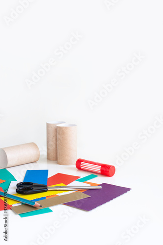Color cardboard trim, pencil, scissors, glue and empty toilet rolls. Set for applique. Activities for children