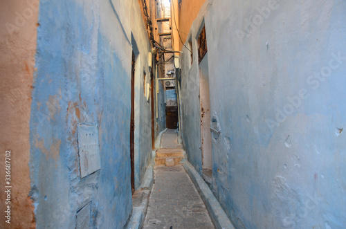 An aisle with blue colour brick wall at Fes. © peacefoo