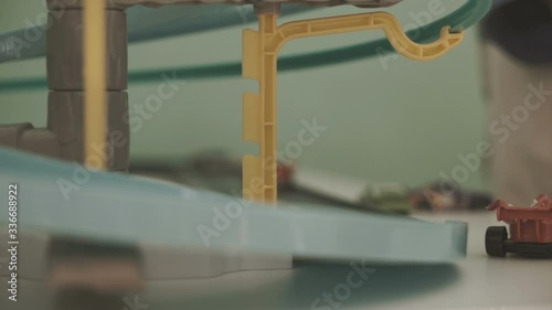 Close up of child playning with game track cars photo