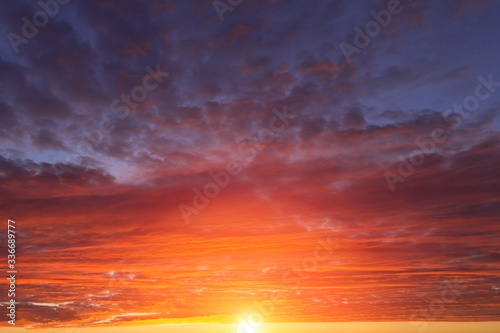 Epic dramatic sunset  sunrise red orange sky with clouds  sun and sunlight 